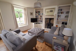 Sunny sitting room with wood burning stove