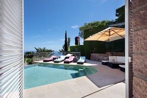 Pool with sun loungers and seating area