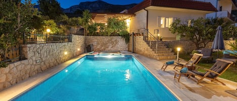 House view from lower terrace at night.