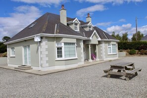 Front and side of home with picnic table