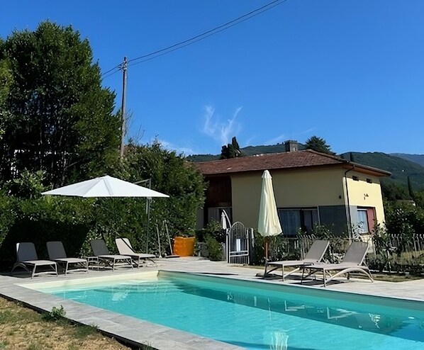 Front of house with private pool in foreground
