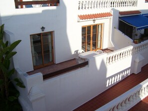 Large balcony with table and chairs