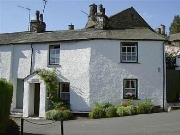 Front of cottage with bench