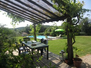 Terrace area for outside dining overlooking the pool. 