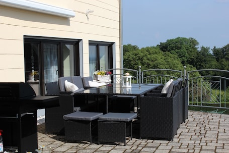Terrasse mit Gartenmöbeln und Gasgrill