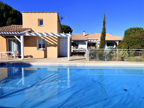 La piscine, la villa 3 pièces à gauche, la villa principale au fond