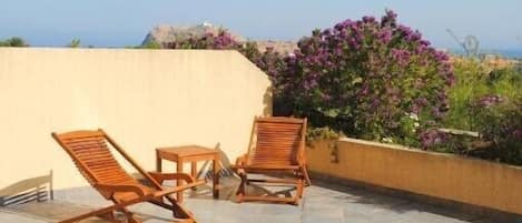 grande terrasse avec mobilier. vue mer et ile de la Pietra.