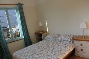 Bedroom 1 has a double aspect onto the mountains and a day bed for reading.
