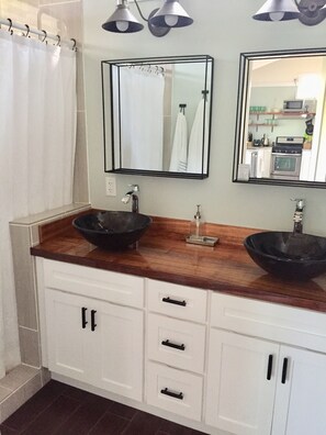Double sink in master bath with shower and door to toilet for privacy.