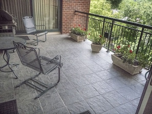 Outside porch with flowers and grill