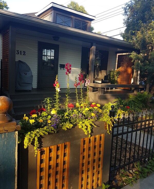 Cosy private front porch is great to sit and observe the neighbourhood activity