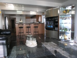 Standing at oceanfront window facing into the kitchen from the front room