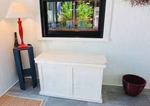 Front sun porch storage chest for beach toys.
