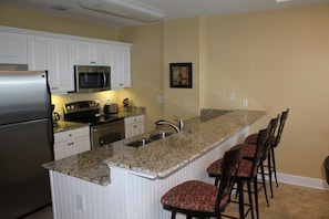 Kitchen and Bar Area; Stainless appliances and Granite Counter Tops