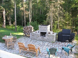 The outdoor stone patio with fireplace