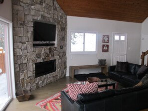 Beautiful telluride stone fireplace and contemporary glass fireplace with 50" tv