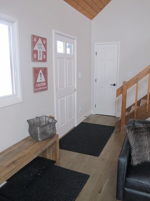 Entry way complete with bench and shoe storage and coat closet with short hooks