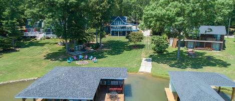 Aerial view of the dock, yard, and fire pit.