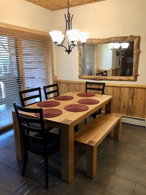 New dining room furniture near the balcony which overlooks the stream