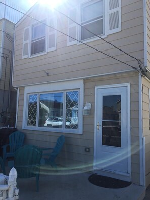 Fenced in front patio with chairs
