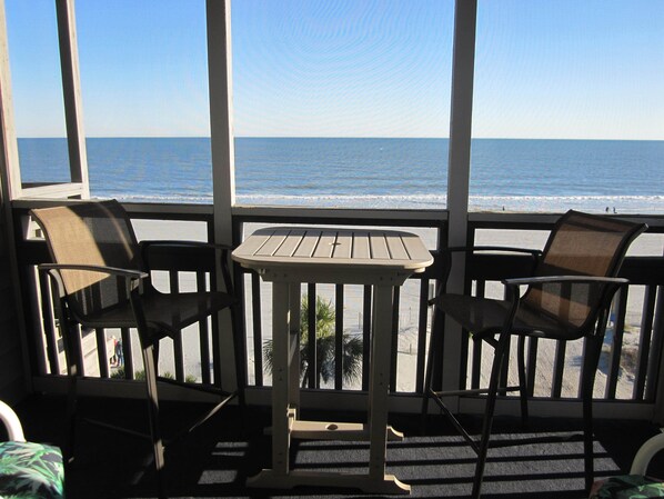 Oceanfront screened balcony located adjacent to living room.