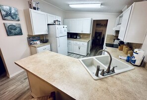 Fully stocked kitchen with bar seating and full laundry room 