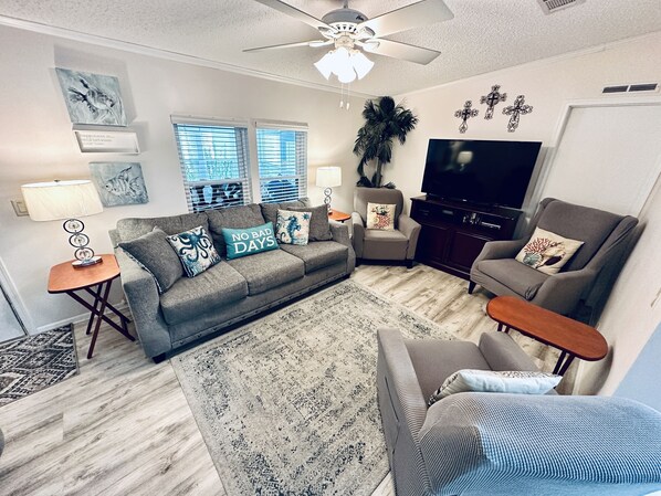 The family room has a 50” Roku TV, two recliners, sofa, loveseat, & chair! 