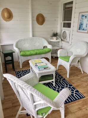 Screened in front porch off the deck with a view of the lake.