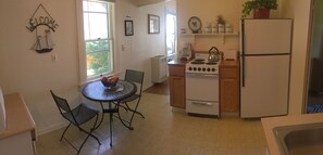 Kitchen includes two top table, stove and oven and a full size refrigerator.  