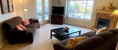 Living Room, with Doors to Deck and Barbecue 
