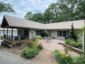 West side of Guest House, covered deck on the left; gas grill on patio
