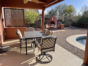 Comfortable outdoor dining area, fan and pull down sunshade for the warmer days