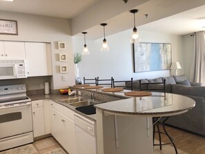 Full kitchen including coffee/K-cup combo. Bar top seating for four (4)