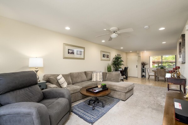 Living room boasts a sofa bed couch and power recliner.