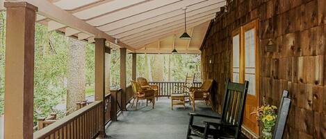 Big, covered front porch with exterior lighting and lots of seating
