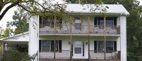 Front porch and balcony, plus huge covered deck on side and back of house.