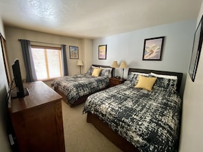 Second Bedroom has 2 Queen Beds, large closet, bureau, smart TV & DVD player.