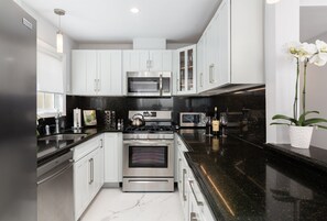 Kitchen is Fully Stocked with Cookware and Servingware
