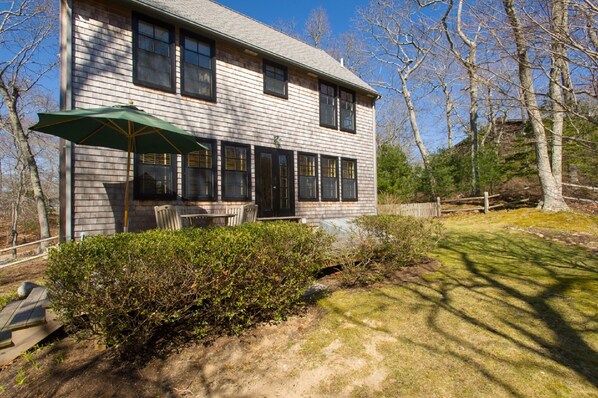 21 Duck Pond Road's sunny deck and back yard overlooking 1.7 acres of woodlands.