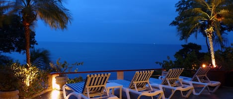 An evening view on the patio.  Landscape lighting adds to the evening ambiance.