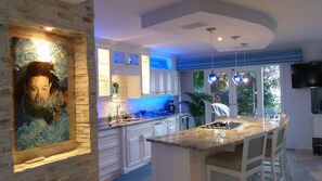 Kitchen next to patio, outdoor dining and living area.