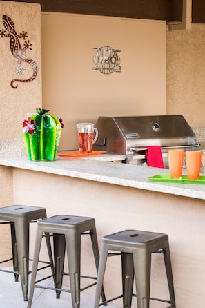 Granite Bar area w/ gas bbq. Misters & ceiling fan in this covered patio area.