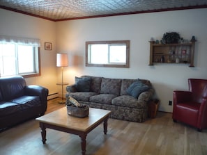 Family room with original tin ceiling and sleeper sofa
