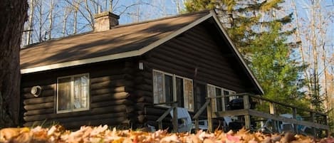 Deck has a charcoal grill and table with four chairs