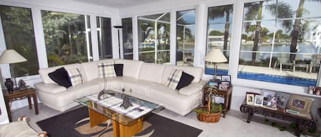 Living room, pool and water beyond, and bird feeders on left 