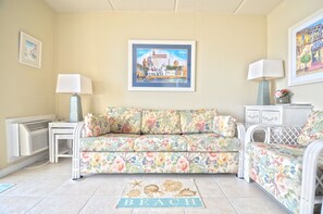 Living area features plenty of seating surrounded by artwork of St. Augustine.