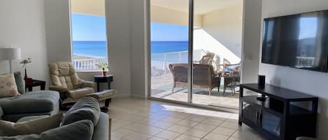 Beautiful Beach Views with a large comfortable couch and a 65"  smart TV