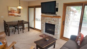 Living Room with Smart TV Gas fireplace and Dining Table