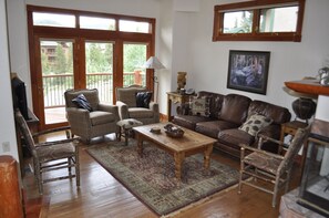 Living room with flat screen cable TV & beautiful mountain view