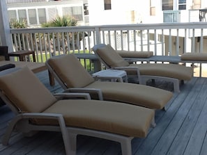 Lounge chairs on back uncovered deck. Sun in morning. Shade in afternoon. View!